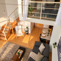 Aerial view of a bright loft-style living room with a fireplace, L-shaped sofa, coffee table, rug, and dining nook beneath a mezzanine balcony.